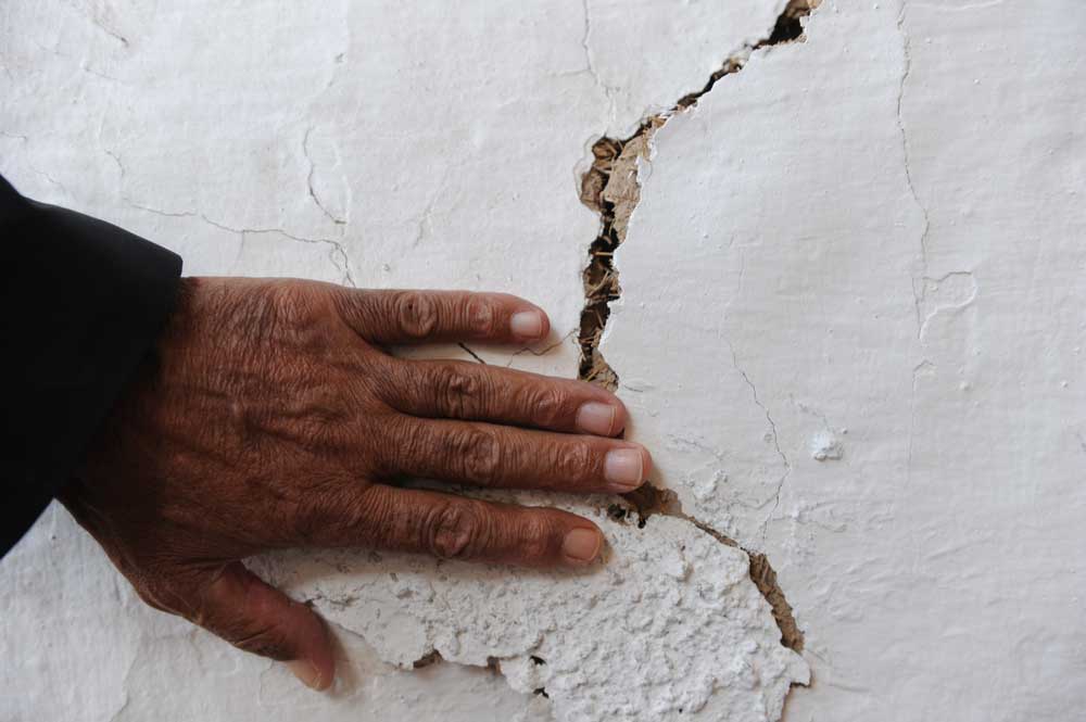 Hand on cracked wall
